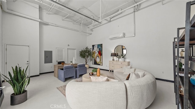 410 W Main St Unit 231, Alhambra, CA 91801 - living room with finished concrete floors, a wall mounted AC, electric panel, a towering ceiling, and baseboards