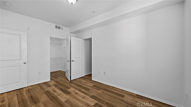 410 W Main St Unit 231, Alhambra, CA 91801 - unfurnished bedroom with wood finished floors, baseboards, a closet, and a walk in closet