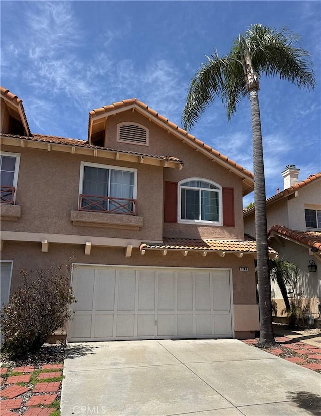 1784 Promenade Pl, Vista, CA 92083 - view of front of property with a garage, a tiled roof, driveway, and stucco siding