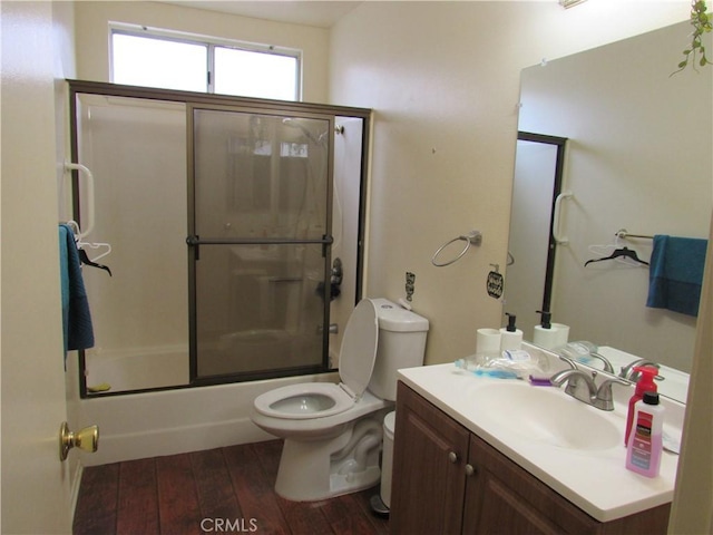 26250 Spaniel Ln, Menifee, CA 92586 - bathroom featuring wood-type flooring, toilet, vanity, and enclosed tub / shower combo