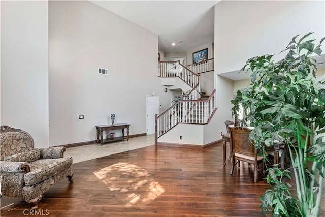 3582 Cedar Ridge Ln, Corona, CA 92881 - living area featuring stairs, wood finished floors, a towering ceiling, and baseboards