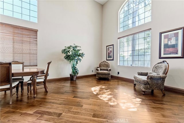 3582 Cedar Ridge Ln, Corona, CA 92881 - sitting room with a high ceiling, wood finished floors, and baseboards
