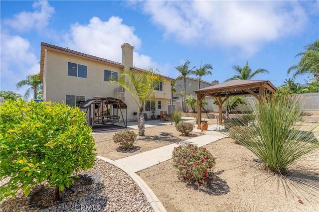 3582 Cedar Ridge Ln, Corona, CA 92881 - rear view of house with a gazebo, a patio, stucco siding, and a chimney