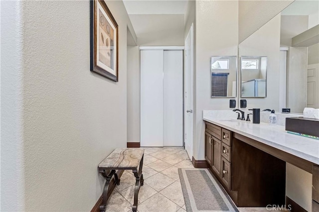 3582 Cedar Ridge Ln, Corona, CA 92881 - bathroom with vanity, baseboards, a textured wall, and tile patterned floors