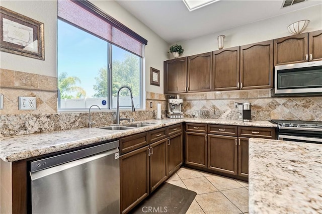 3582 Cedar Ridge Ln, Corona, CA 92881 - kitchen with stainless steel appliances, a sink, tasteful backsplash, and dark brown cabinets