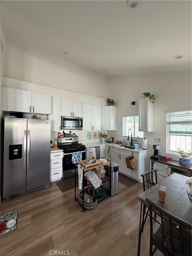 18649 Willard St, Reseda, CA 91335 - kitchen featuring appliances with stainless steel finishes, a sink, white cabinetry, and light countertops
