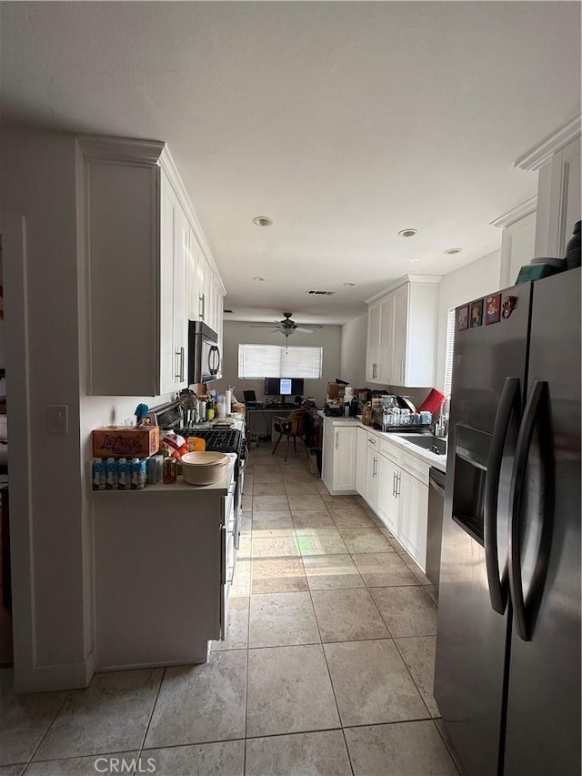 18649 Willard St, Reseda, CA 91335 - kitchen with black appliances, ceiling fan, white cabinets, light tile patterned floors, and a sink