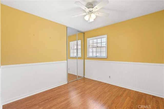 20632 Egret Ln, Huntington Beach, CA 92646 - empty room featuring wainscoting, wood finished floors, and a ceiling fan