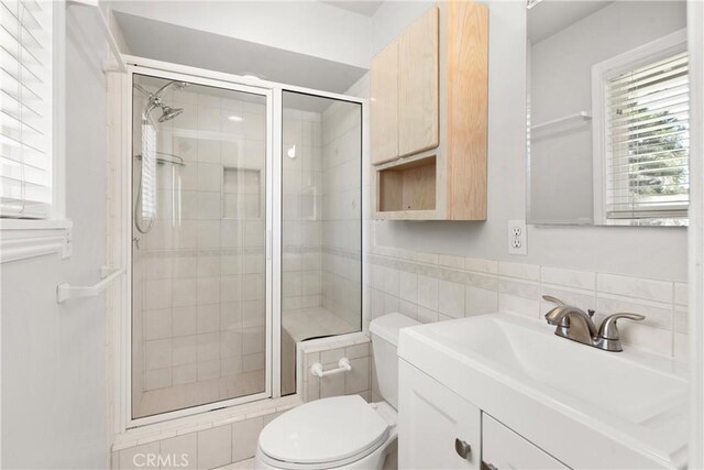 20632 Egret Ln, Huntington Beach, CA 92646 - bathroom featuring toilet, tile walls, a shower stall, and vanity
