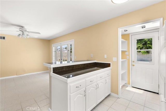 20632 Egret Ln, Huntington Beach, CA 92646 - kitchen featuring a peninsula, white cabinetry, plenty of natural light, and baseboards