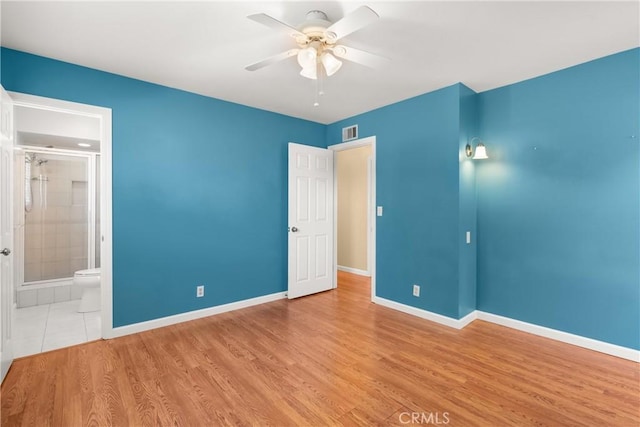 20632 Egret Ln, Huntington Beach, CA 92646 - unfurnished bedroom featuring baseboards, wood finished floors, connected bathroom, and a ceiling fan