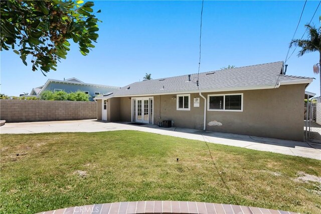 20632 Egret Ln, Huntington Beach, CA 92646 - rear view of property with stucco siding, french doors, a patio area, and roof with shingles
