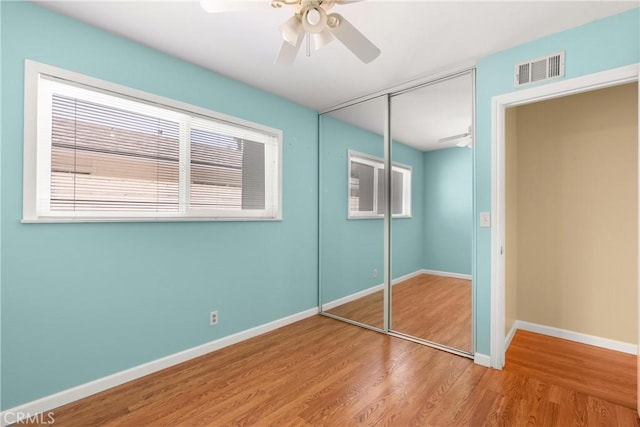 20632 Egret Ln, Huntington Beach, CA 92646 - unfurnished bedroom featuring wood finished floors, a closet, baseboards, and a ceiling fan