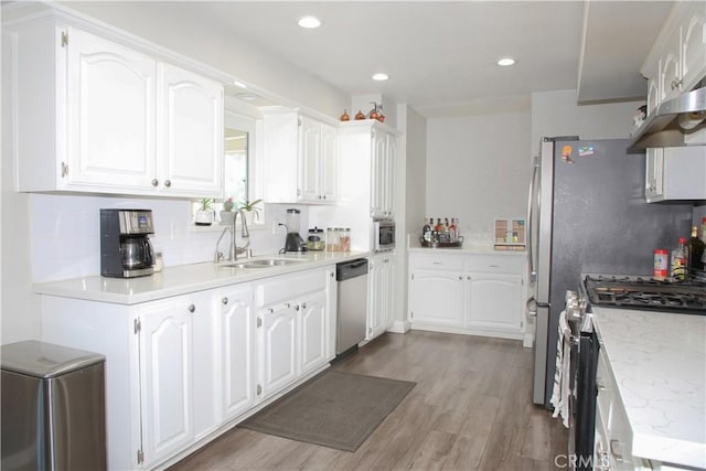 17471 Reed St, Fontana, CA 92336 - kitchen featuring stainless steel appliances, a sink, white cabinets, light wood-style floors, and recessed lighting