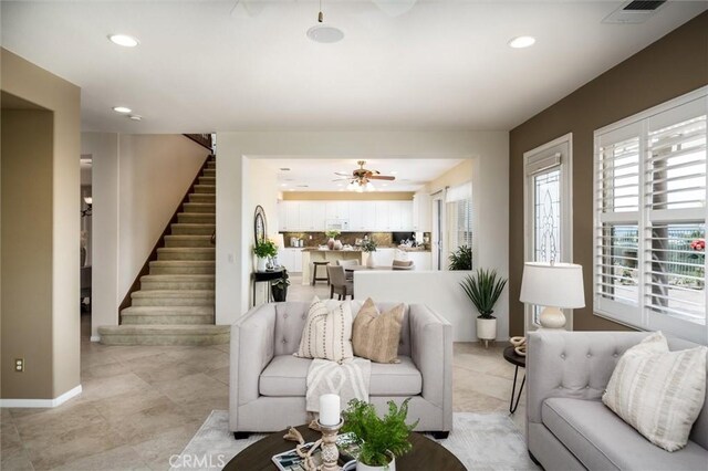 33850 Sattui St, Temecula, CA 92592 - living area with stairs, healthy amount of natural light, recessed lighting, a ceiling fan, and baseboards