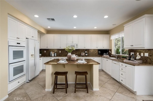 33850 Sattui St, Temecula, CA 92592 - kitchen with white appliances, a kitchen island, white cabinetry, and recessed lighting