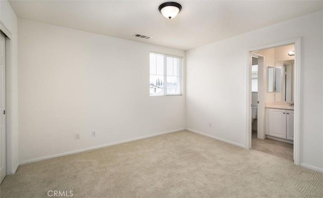 33850 Sattui St, Temecula, CA 92592 - unfurnished bedroom with light carpet, baseboards, ensuite bath, and a sink