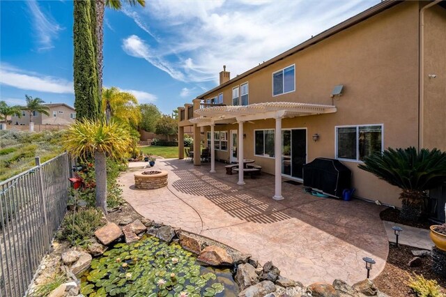 33850 Sattui St, Temecula, CA 92592 - fenced backyard featuring an outdoor fire pit, a pergola, and a patio area