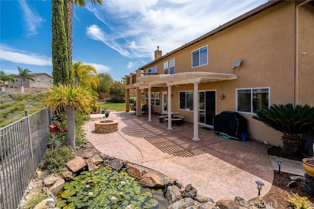 33850 Sattui St, Temecula, CA 92592 - fenced backyard featuring a fire pit, a pergola, a patio area, and a grill