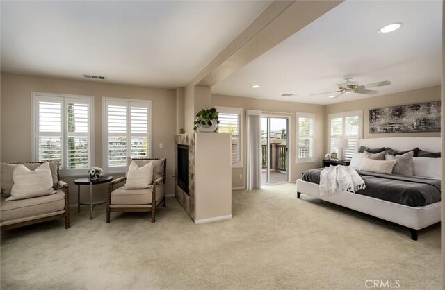 33850 Sattui St, Temecula, CA 92592 - bedroom featuring access to exterior, light carpet, baseboards, a glass covered fireplace, and a ceiling fan