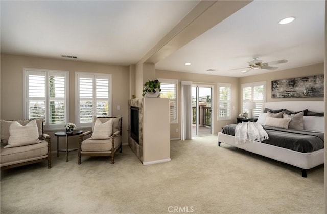 33850 Sattui St, Temecula, CA 92592 - bedroom with access to exterior, light colored carpet, a glass covered fireplace, ceiling fan, and recessed lighting
