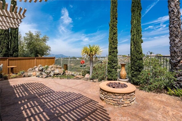 33850 Sattui St, Temecula, CA 92592 - fenced backyard featuring a patio, an outdoor fire pit, a mountain view, and a pergola
