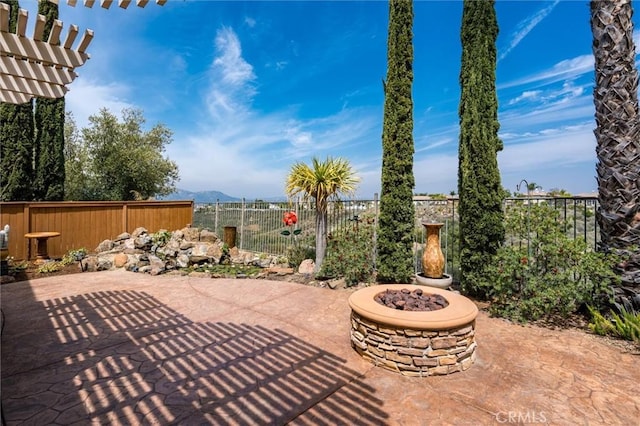 33850 Sattui St, Temecula, CA 92592 - fenced backyard with a patio, an outdoor fire pit, a mountain view, and a pergola