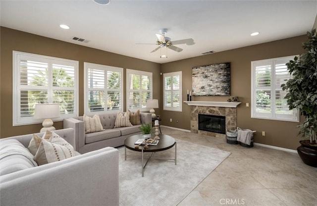 33850 Sattui St, Temecula, CA 92592 - living area with healthy amount of natural light, a ceiling fan, baseboards, a premium fireplace, and recessed lighting