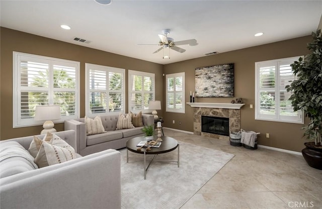 33850 Sattui St, Temecula, CA 92592 - living area with healthy amount of natural light, ceiling fan, a premium fireplace, light tile patterned floors, and recessed lighting