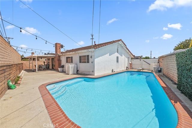 15113 Hayford St, La Mirada, CA 90638 - view of swimming pool featuring a fenced backyard, a patio area, central AC unit, and a diving board