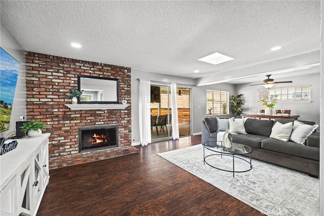 15113 Hayford St, La Mirada, CA 90638 - living area featuring a textured ceiling, wood finished floors, a fireplace, recessed lighting, and ceiling fan