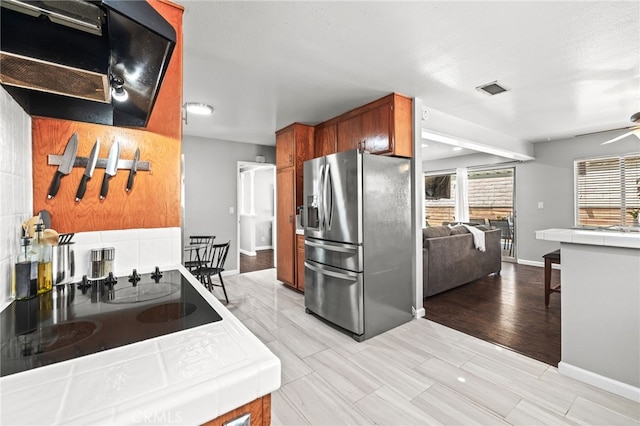 15113 Hayford St, La Mirada, CA 90638 - kitchen featuring stainless steel refrigerator with ice dispenser, tile countertops, extractor fan, a ceiling fan, and baseboards