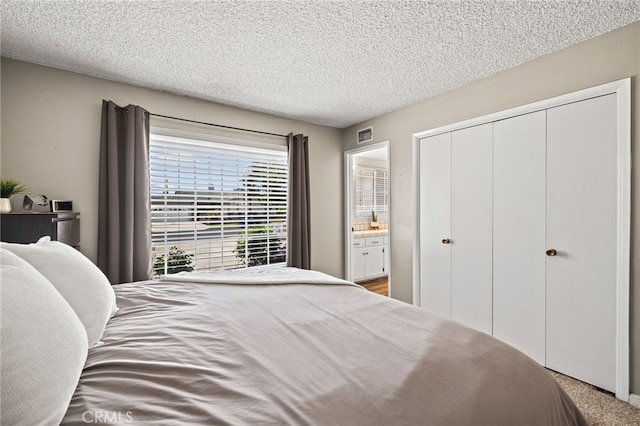 15113 Hayford St, La Mirada, CA 90638 - bedroom featuring a textured ceiling, a closet, ensuite bathroom, and carpet flooring