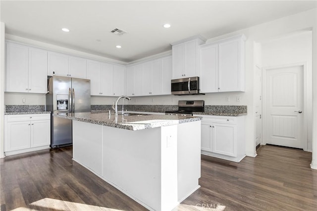 34048 Thistlewood Ave, Murrieta, CA 92563 - kitchen with appliances with stainless steel finishes, a sink, dark wood finished floors, white cabinets, and recessed lighting