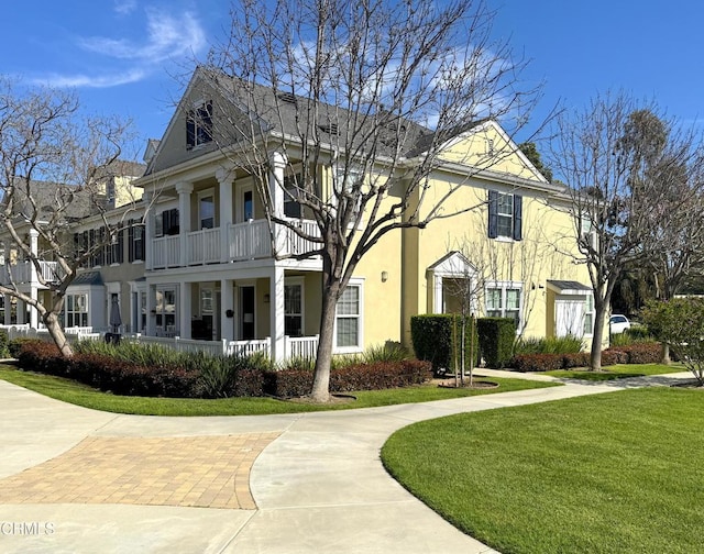 5611 Dorsey St, Ventura, CA 93003 - view of front facade featuring stucco siding, a front lawn, a balcony, and a porch