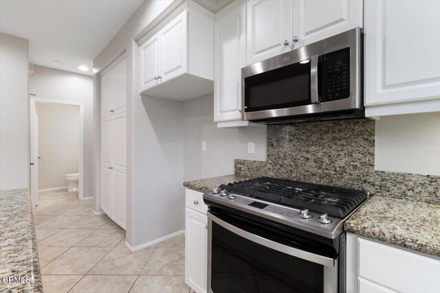 5611 Dorsey St, Ventura, CA 93003 - kitchen featuring stainless steel appliances, tasteful backsplash, white cabinetry, light stone countertops, and recessed lighting