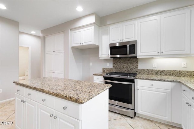 5611 Dorsey St, Ventura, CA 93003 - kitchen with appliances with stainless steel finishes, light tile patterned floors, recessed lighting, a center island, and light stone countertops