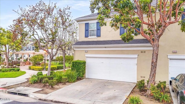 5611 Dorsey St, Ventura, CA 93003 - traditional-style home with stucco siding, an attached garage, concrete driveway, and a shingled roof