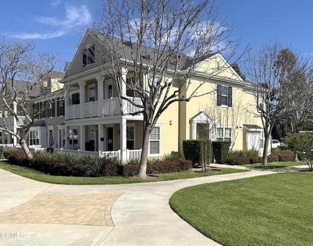 5611 Dorsey St, Ventura, CA 93003 - view of front of property featuring stucco siding, a front lawn, a balcony, and a porch