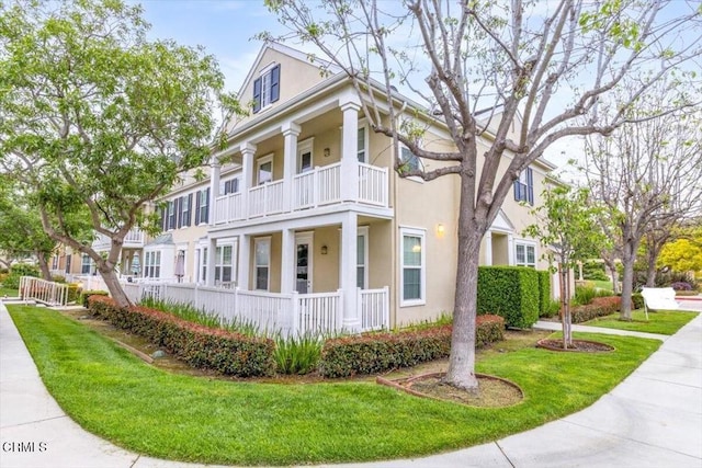 5611 Dorsey St, Ventura, CA 93003 - view of front of home featuring a balcony, stucco siding, and a front yard