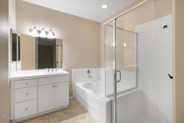5611 Dorsey St, Ventura, CA 93003 - bathroom featuring vanity, a shower stall, a garden tub, and tile patterned flooring