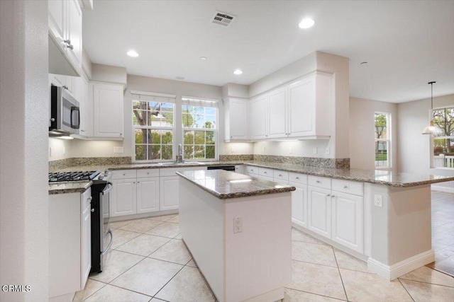 5611 Dorsey St, Ventura, CA 93003 - kitchen featuring gas range, stainless steel microwave, a peninsula, healthy amount of natural light, and recessed lighting