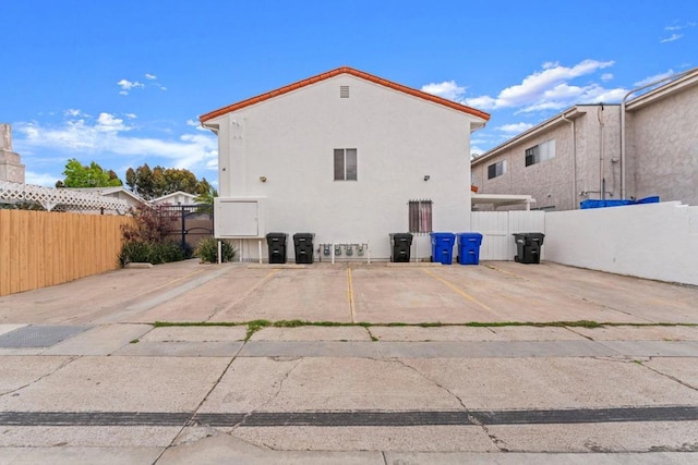 4532 Dawson Ave Unit 3, San Diego, CA 92115 - rear view of house featuring uncovered parking and stucco siding