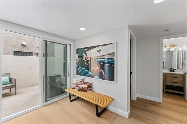 4532 Dawson Ave Unit 3, San Diego, CA 92115 - corridor with wood finished floors, a textured ceiling, baseboards, recessed lighting, and a sink