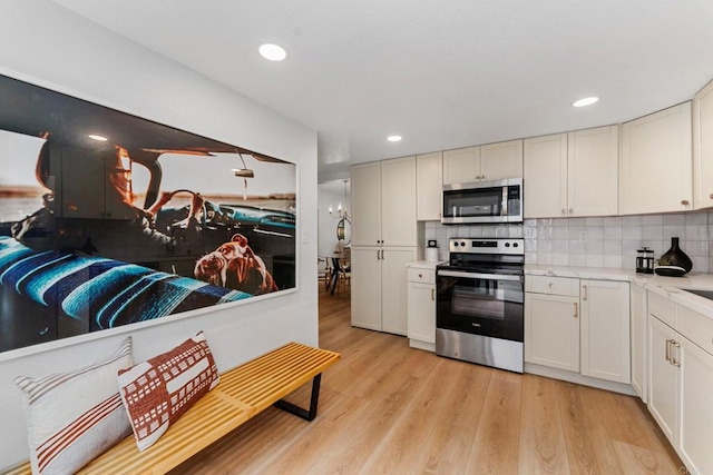 4532 Dawson Ave Unit 3, San Diego, CA 92115 - kitchen with stainless steel appliances, light countertops, light wood finished floors, tasteful backsplash, and recessed lighting