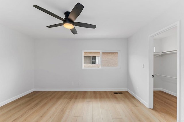 4532 Dawson Ave Unit 3, San Diego, CA 92115 - unfurnished bedroom with light wood-style floors, a walk in closet, baseboards, and a ceiling fan
