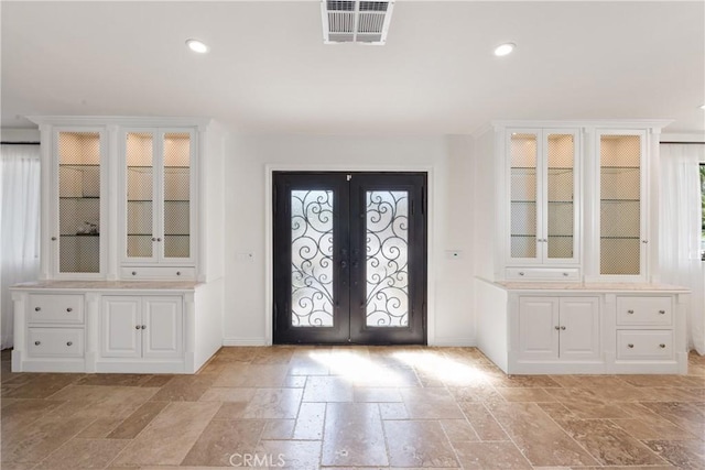 72408 Desert Dr, Rancho Mirage, CA 92270 - foyer entrance featuring stone tile flooring, french doors, recessed lighting, and baseboards