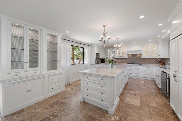 72408 Desert Dr, Rancho Mirage, CA 92270 - kitchen featuring stone tile floors, a chandelier, white cabinets, recessed lighting, and ornamental molding