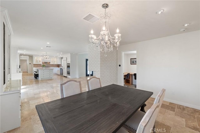 72408 Desert Dr, Rancho Mirage, CA 92270 - dining space featuring a chandelier, stone tile flooring, recessed lighting, and baseboards