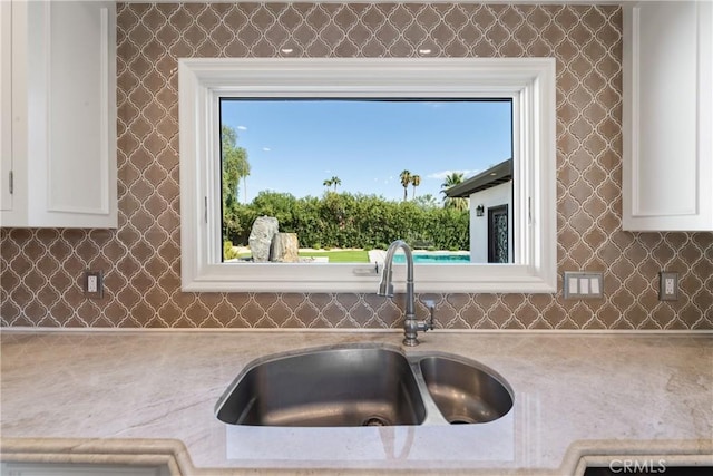 72408 Desert Dr, Rancho Mirage, CA 92270 - kitchen featuring a sink, white cabinets, and decorative backsplash